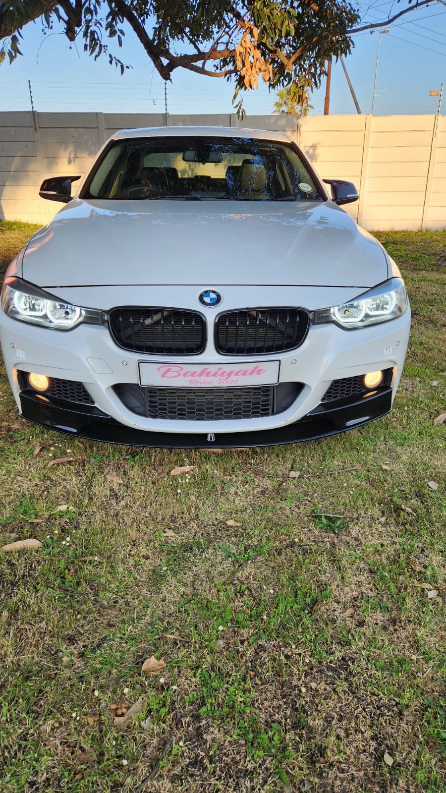 White BMW with a personalised matric ball name plate on the front